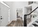 Bright entryway with hardwood floors and a staircase, creating a welcoming space at 5420 Avonshire Ln, Cumming, GA 30040