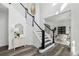 Elegant foyer with hardwood floors, staircase, and bright lighting at 5420 Avonshire Ln, Cumming, GA 30040