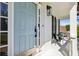 Inviting front porch with a light blue door, black lanterns and seating at 5420 Avonshire Ln, Cumming, GA 30040