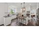 Modern kitchen featuring white cabinets, granite countertops, stainless steel appliances, and a center island at 5420 Avonshire Ln, Cumming, GA 30040