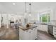 Spacious kitchen with modern appliances, center island, and open layout, flowing into dining and living areas at 5420 Avonshire Ln, Cumming, GA 30040