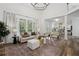 Bright living room with high ceilings, neutral decor, modern lighting, and expansive windows at 5420 Avonshire Ln, Cumming, GA 30040
