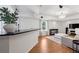 Open living room featuring a built in bar, modern sofa, recessed lighting, and hardwood flooring at 5420 Avonshire Ln, Cumming, GA 30040
