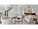 Bright living room featuring hardwood floors, white walls, and stylish furniture, open to the dining area at 5420 Avonshire Ln, Cumming, GA 30040