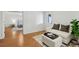 Open-concept living space with sofa, ottoman, and a view into the adjacent room at 5420 Avonshire Ln, Cumming, GA 30040