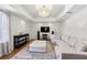 Cozy living room featuring recessed lighting, a modern chandelier, and a plush sectional sofa at 5420 Avonshire Ln, Cumming, GA 30040