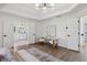 Bright primary bedroom boasts wood floors and a view of the primary bath at 5420 Avonshire Ln, Cumming, GA 30040