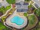 Aerial view of the community clubhouse, pool, lush landscaping, and parking areas at 3505 Chattahoochee Summit Se Ln # 25, Atlanta, GA 30339