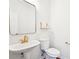 Bright half bathroom featuring modern gold fixtures and a pedestal sink at 3505 Chattahoochee Summit Se Ln # 25, Atlanta, GA 30339
