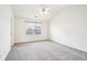 Bedroom featuring a ceiling fan, neutral carpeting, and a large window at 3505 Chattahoochee Summit Se Ln # 25, Atlanta, GA 30339