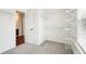 Walk-in closet featuring shelving, hardwood flooring, and a white door at 3505 Chattahoochee Summit Se Ln # 25, Atlanta, GA 30339