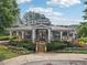Charming community clubhouse featuring a covered porch, stone accents, and manicured landscaping at 3505 Chattahoochee Summit Se Ln # 25, Atlanta, GA 30339