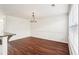 Open-concept dining room features hardwood floors and modern chandelier at 3505 Chattahoochee Summit Se Ln # 25, Atlanta, GA 30339