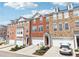 View of attractive townhomes with garages, driveways, and manicured front yard at 3505 Chattahoochee Summit Se Ln # 25, Atlanta, GA 30339