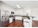 Bright kitchen with white cabinetry, stainless steel appliances, and dark countertops and flooring at 3505 Chattahoochee Summit Se Ln # 25, Atlanta, GA 30339