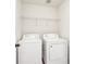 Practical laundry room with a washer and dryer, equipped with storage shelves for convenience at 3505 Chattahoochee Summit Se Ln # 25, Atlanta, GA 30339