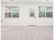 Spacious living room featuring two windows, neutral carpet, and a back door at 3505 Chattahoochee Summit Se Ln # 25, Atlanta, GA 30339