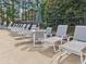 Poolside lounge chairs and tables offer a comfortable space to relax and enjoy the sun at 3505 Chattahoochee Summit Se Ln # 25, Atlanta, GA 30339