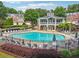 Community pool with lounge chairs, umbrellas and clubhouse at 3505 Chattahoochee Summit Se Ln # 25, Atlanta, GA 30339