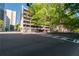 A city street corner with a parking garage, tree-lined sidewalks, and urban infrastructure at 20 Marietta St. Nw #12D, Atlanta, GA 30303