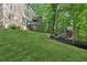 Expansive backyard with a multi-level deck, play set, and serene wooded backdrop at 6795 Preston Glen Dr, Alpharetta, GA 30005