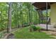 Spacious backyard featuring a deck, stairs, play set and natural beauty at 6795 Preston Glen Dr, Alpharetta, GA 30005