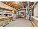 Unfinished basement with shelving units and workbench, offering ample storage space at 6795 Preston Glen Dr, Alpharetta, GA 30005