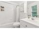 All-white bathroom featuring a bathtub and shower with white tiling and vanity with medicine cabinet at 6795 Preston Glen Dr, Alpharetta, GA 30005
