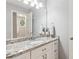 Bathroom featuring granite countertop and ample storage space, plus a view to an adjacent room at 6795 Preston Glen Dr, Alpharetta, GA 30005