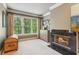 Comfortable bedroom featuring a fireplace, large windows, and a neutral color palette at 6795 Preston Glen Dr, Alpharetta, GA 30005