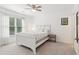 Bright bedroom featuring a ceiling fan, white-painted furniture, and natural light from the window at 6795 Preston Glen Dr, Alpharetta, GA 30005