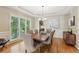 Elegant dining room with a tray ceiling, large window, and hardwood floors at 6795 Preston Glen Dr, Alpharetta, GA 30005