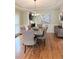 Elegant dining room with hardwood floors, wainscoting, modern chandelier, and seating for six at 6795 Preston Glen Dr, Alpharetta, GA 30005