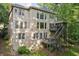 Rear exterior view of a two-story home showcasing a spacious deck and wooded surroundings at 6795 Preston Glen Dr, Alpharetta, GA 30005