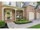 Charming front porch with rocking chairs and a meticulously landscaped garden bed at 6795 Preston Glen Dr, Alpharetta, GA 30005