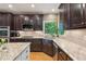 Well-equipped kitchen with granite countertops, custom cabinets, and stainless steel appliances at 6795 Preston Glen Dr, Alpharetta, GA 30005