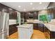 Spacious kitchen with island, stainless appliances, custom cabinetry, and hardwood flooring at 6795 Preston Glen Dr, Alpharetta, GA 30005