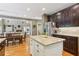 Open kitchen concept with a center island and an adjacent dining area and living room at 6795 Preston Glen Dr, Alpharetta, GA 30005
