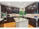 Gourmet kitchen featuring dark cabinetry, a center island, stainless steel appliances, and hardwood floors at 6795 Preston Glen Dr, Alpharetta, GA 30005