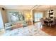 Inviting living room with hardwood floors, tray ceiling, large windows, and a comfortable seating arrangement at 6795 Preston Glen Dr, Alpharetta, GA 30005