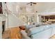 Open-concept living room and kitchen with fireplace and staircase at 6795 Preston Glen Dr, Alpharetta, GA 30005