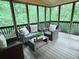 Relaxing screened porch with outdoor seating, perfect for enjoying nature and fresh air at 6795 Preston Glen Dr, Alpharetta, GA 30005