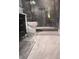 Modern bathroom featuring a glass-enclosed shower, stylish vanity, and marble-patterned flooring at 3629 Embry Cir, Atlanta, GA 30341