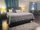 Inviting bedroom with a cozy bed, modern lighting, and a functional desk area at 3629 Embry Cir, Atlanta, GA 30341