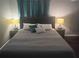 Comfortable bedroom featuring a well-lit bed and classic decor lamps on the nightstands at 3629 Embry Cir, Atlanta, GA 30341