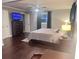 Spacious bedroom with hardwood floors, a ceiling fan, and a comfortable bed and workspace at 3629 Embry Cir, Atlanta, GA 30341