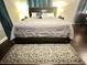 Cozy bedroom featuring a comfortable bed and a stylish area rug on the hardwood floors at 3629 Embry Cir, Atlanta, GA 30341