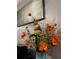 Close up of a flower arrangement with bright orange flowers in a blue vase at 3629 Embry Cir, Atlanta, GA 30341
