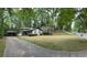 Charming home with a two-car garage, landscaped lawn, and mature trees surrounding the property at 3629 Embry Cir, Atlanta, GA 30341