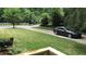 Well-manicured front yard with a paved driveway and black sedan parked near the house at 3629 Embry Cir, Atlanta, GA 30341